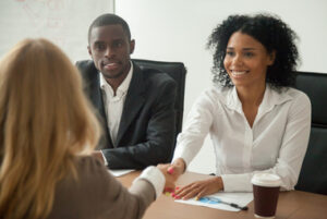 African american hr team welcoming female applicant at job interview